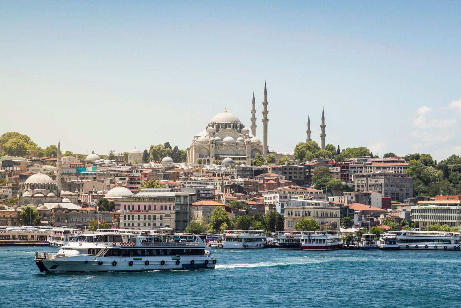 Scenic view of a bustling cityscape by the waterfront with historic architecture Scenic view of a bustling cityscape by the waterfront with historic architecture